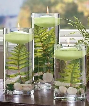 floating candle centerpieces with greenery